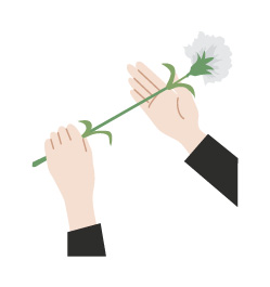 花を受け取り、左手で花の根元を持ち、右手を花の下に軽く添える。